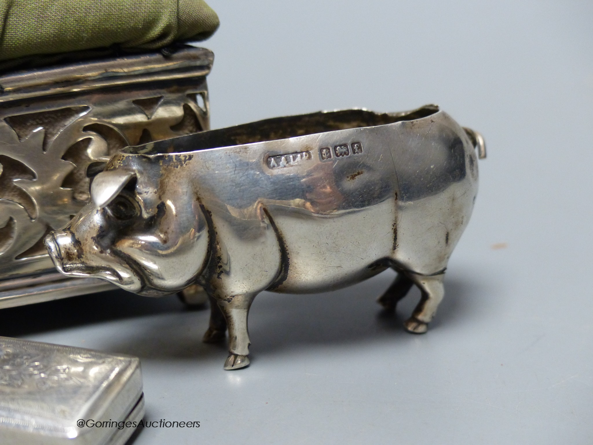 Two silver mounted pin cushions including a pig (lacking cushion) and a 19th century silver vinaigrette.